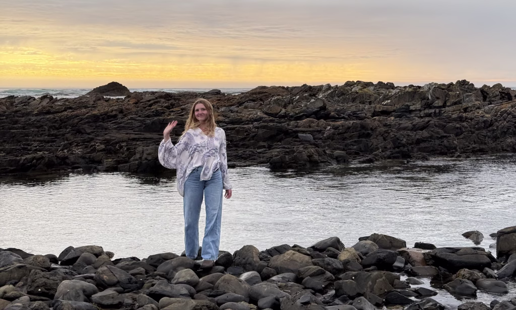 A girl waves at the camera on Tasmania's Northwest Coast.